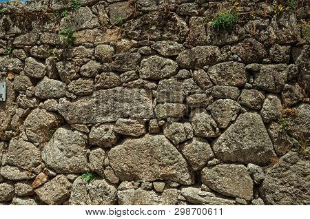 Close-up Of Old Wall Made Of Large Rough Stones Forming A Charming Background At Alvoco Da Serra. A 