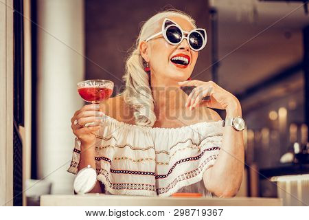 Laughing Long-haired Senior Woman Wearing Weird Glasses
