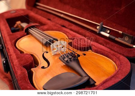 Violin And Bow In Dark Red Case. Close Up View Of A Violin Strings And Bridge