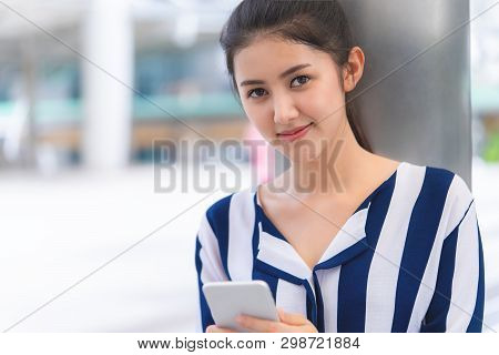 Portrait Of Attractive Woman Using Phone Outdoor