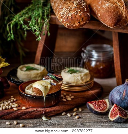 Soft Spreadable French Stinky Cheese On A Slice Of Bread With Fruit And Pine Nuts, Square