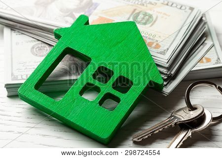 Wooden Hut With Money And Keys On A White Background. Buying Or Renting Or Selling. Concept Remont O