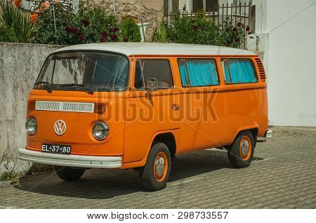 Unhais Da Serra, Portugal - July 15, 2018. Old Orange Volkswagen Van Perfectly Preserved, In An Alle