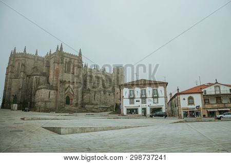 Cathedral Facade And Old Buildings In The Morning Mist