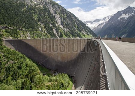 Finkenberg, Austria - June 9, 2018: People On Top Of The Schlegeis Dam In The Zillertal Valley.