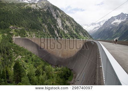 Finkenberg, Austria - June 9, 2018: People On Top Of The Schlegeis Dam In The Zillertal Valley.