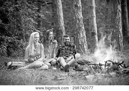 Summer Vacation In Camp. Bearded Man And Women Smile At Bonfire. Happy Friends At Campfire. Hipster 