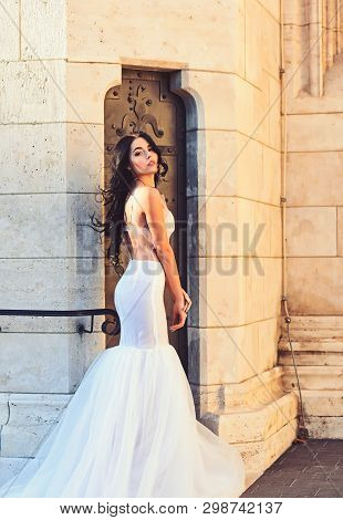 Sexy Girl In White Dress With Stylish Hair. Sexy Girl In White Sedding Dress Pose At Stony Wall.