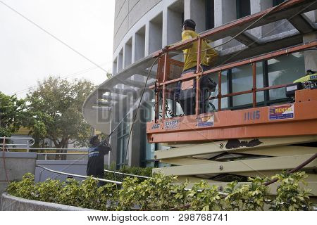 Bayamon/puerto Rico - February 26, 2019: Hispanic Man Uses High Pressure Washer Machine To Clean Ext