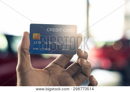 Man Holding Credit Card For Car Blurred Bokeh Background E-shopping 
Marketing Digital, Consumer Pur