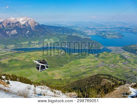 Mt. Stanserhorn, Switzerland - May 7, 2016: People In A Gondola Of The Stanserhorn Cabrio Aerial Cab