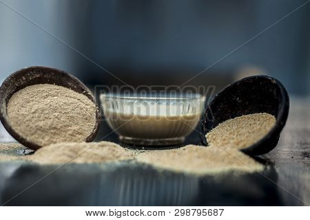 Clay Bowl On Wooden Surface Full Of Poppy Seeds Or Khus Or Opium Poppy Or Bread Seed Poppy With Its 