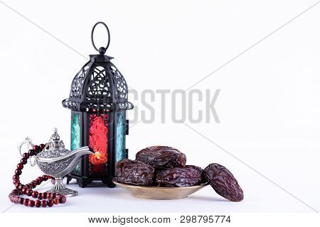 Ramadan Food And Drinks Concept. Ramadan Lantern With Arabian Lamp, Wood Rosary, Dates Fruit And Lig