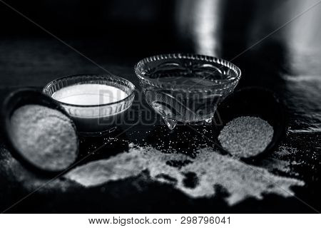 Clay Bowl On Wooden Surface Full Of Poppy Seeds Or Khus Or Opium Poppy Or Bread Seed Poppy With Its