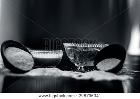 Clay Bowl On Wooden Surface Full Of Poppy Seeds Or Khus Or Opium Poppy Or Bread Seed Poppy With Its