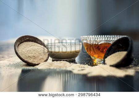 Clay Bowl On Wooden Surface Full Of Poppy Seeds Or Khus Or Opium Poppy Or Bread Seed Poppy With Its