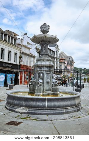 Lourdes, France - June 18, 2018: Place Marcadal. Old Fountain With Stone Fish On The Square.