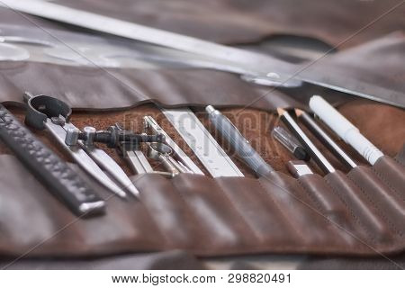Leather Crafting Diy Tools And Templates On Workbench. Instruments In Brown Leather Case.