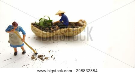 Conceptual Illustration, Keep Struggle, Mini Figure Man Farming At Limited Area, Peanut Skin, With W