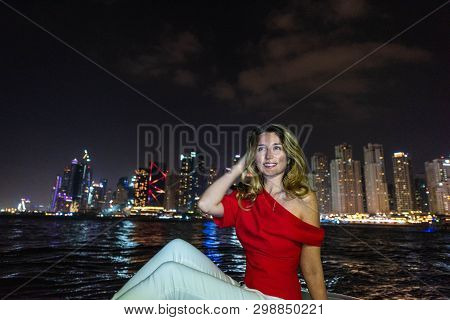 Woman At Jbr Dubai Marina, United Arab Emirates. Attractive Girl On A Boat Admiring Marina Jbr View 