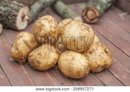 Many Fresh Potatoes On The Wooden Table