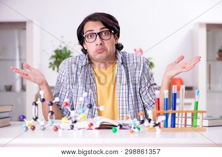 Young student physicist preparing for exam at home    