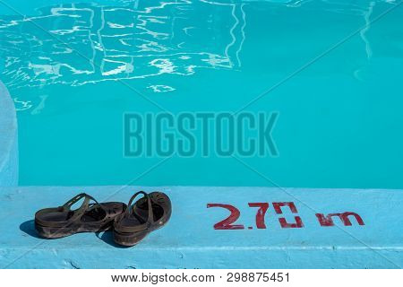 Sandals By A Swimming Pool With 2.70m Depth Marking