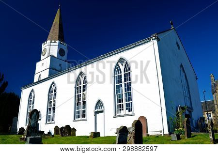 A View Of The White Church Building On The Banks Of The River Earn In Comrie, Perthshire