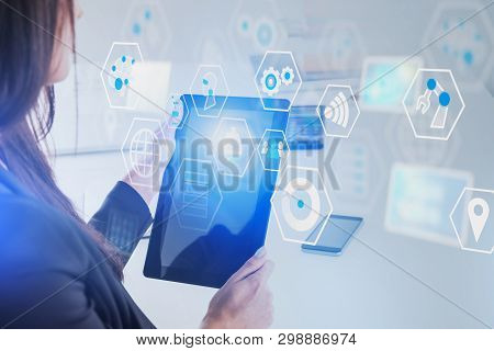 Unrecognizable Woman Holding Tablet Computer In Blurred White Office With Double Exposure Of Digital