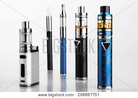 Electronic Cigarettes Or Vaping Devices On White Background
