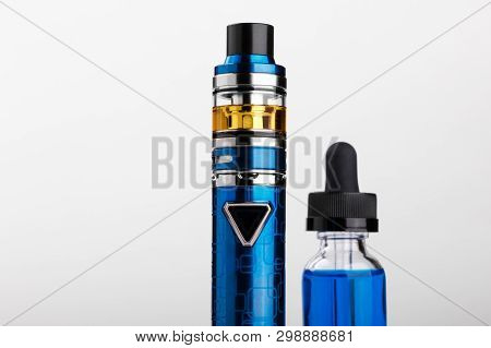 Electronic Cigarette And Bottle With Vape Liquid On White Background