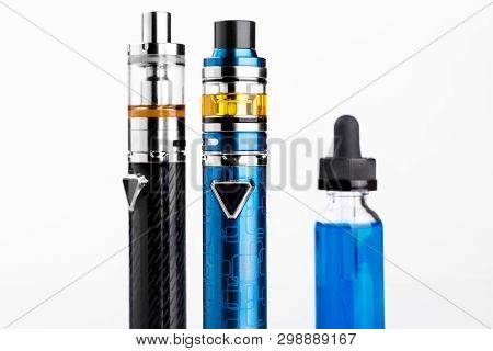 Electronic Cigarettes And Bottle With Vape Liquid On White Background