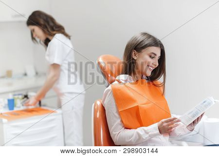 Dental Clinic. Reception, Examination Of The Patient. Teeth Care. Young Woman Undergoes A Dental Exa