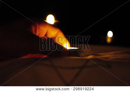 Candles Burning Over The Star Of David In Memory Of The Dead.