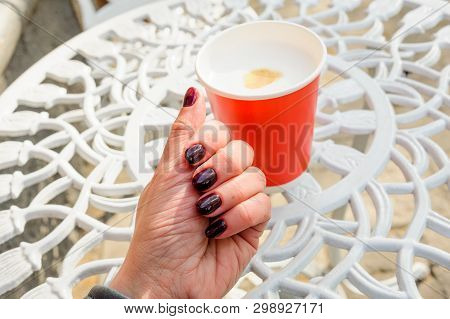 beautiful red paper cup with latte in spring