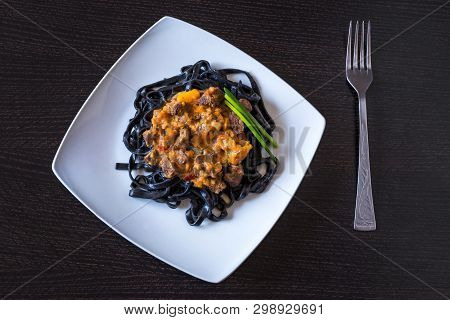 Black Pasta With Cuttlefish Ink. Pasta Of Durum Wheat Semolina With Squid Ink With Beef And Sweet Pe