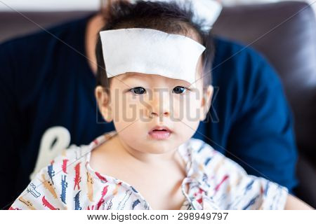 Unhappy Asian Little Baby Sick With Cool Fever Jel Pad On Forehead
