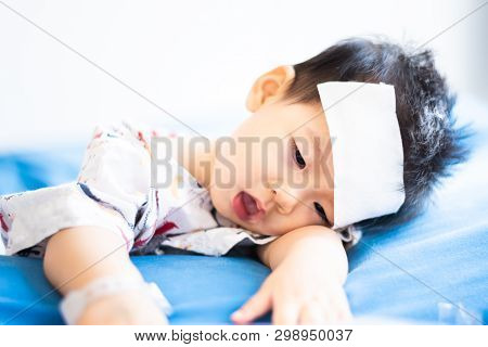 Unhappy Asian Little Baby Sick With Cool Fever Jel Pad On Forehead