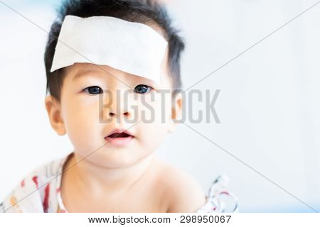 Unhappy Asian Little Baby Sick With Cool Fever Jel Pad On Forehead