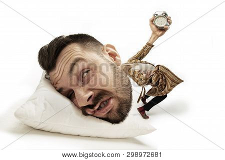 No Time For Breakfest Again. Big Head On Small Body Lying On The Pillow. Man In Home Suit Holding Al