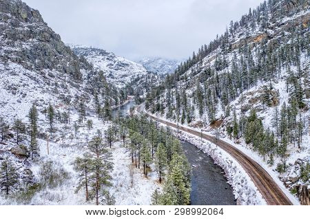mountain river canyon in springtime snowstorm  - Poudre River in northern Colorado aerial view