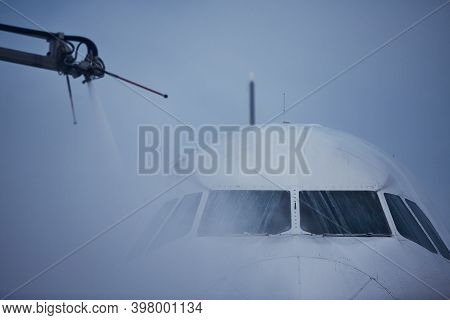 Winter Frosty Day At Airport. Deicing Of Airplane Before Flight.