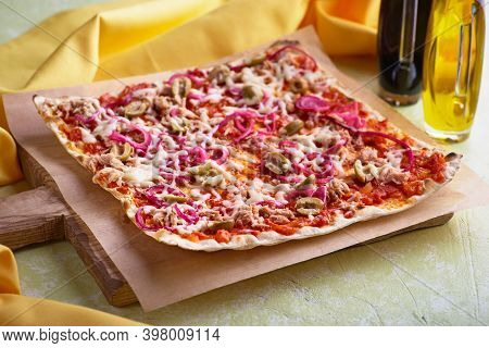 Tart Flambee With Tuna Purple Onions, Cheese, Green Olives. Flammkuchen Selective Focus