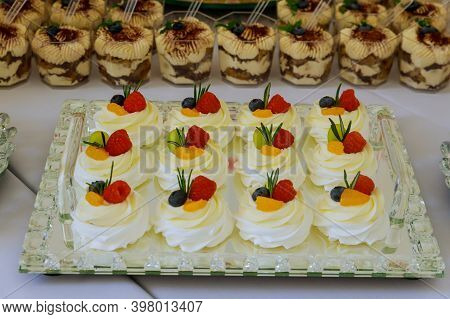 Mini Pavlova Cakes With Whipped Cream And Fresh Fruits. Mini Dessert.