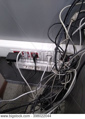 Electric Wires Of Different Thickness In Gray Tones In The Office Space. High Quality Photo