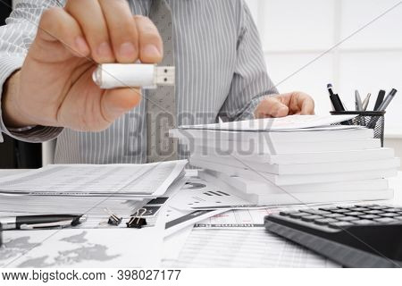 business concept - businessman's working table close view, shows the USB flash drive
