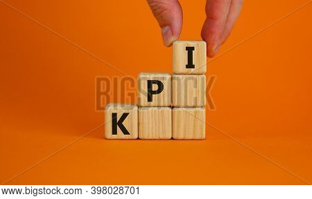 Kpi Symbol. Wood Cubes With Acronym 'kpi, Key Performance Indicator' Stacking As Step Stair On Orang