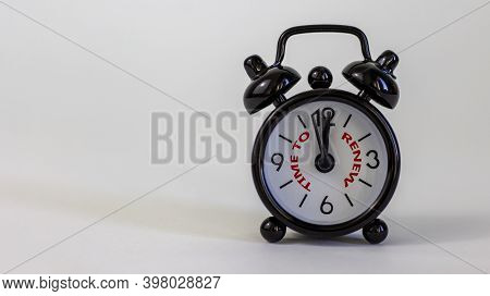 Time To Renew Concept. Beautiful Black Alarm Clock With Words 'time To Renew'. White Table. Beautifu