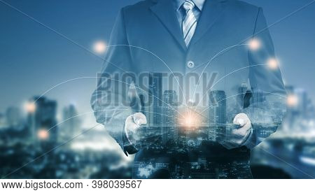 Double Exposure Of Success Businessman Using Digital Tablet With City Landscape Background And Netwo