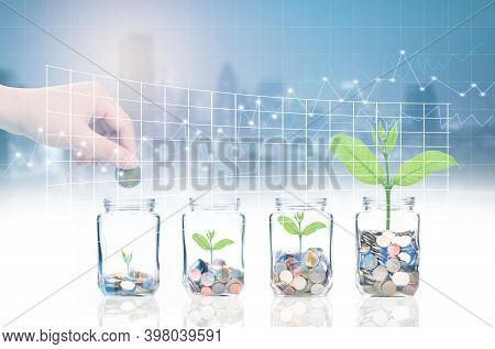 Hand Putting Coins And Seed In Bottle On Cityscape Photo Blurred Cityscape And Forex Graph Backgroun